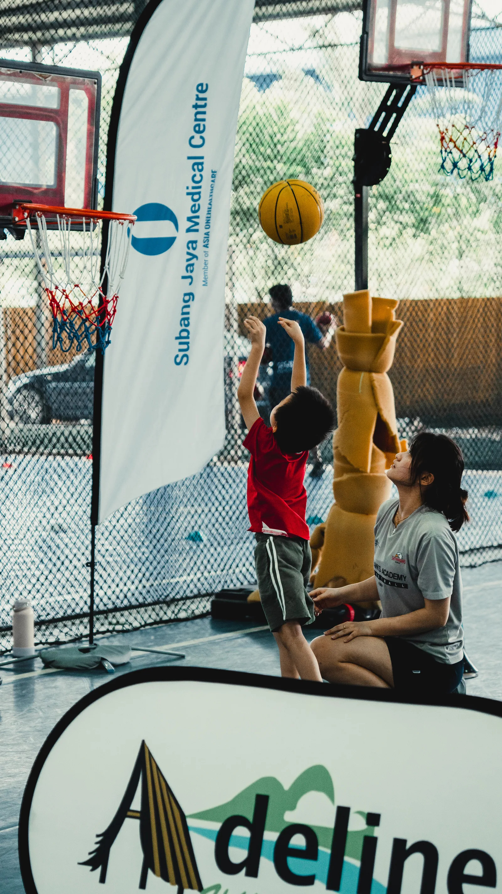 Kids ages 5–7 playing basketball