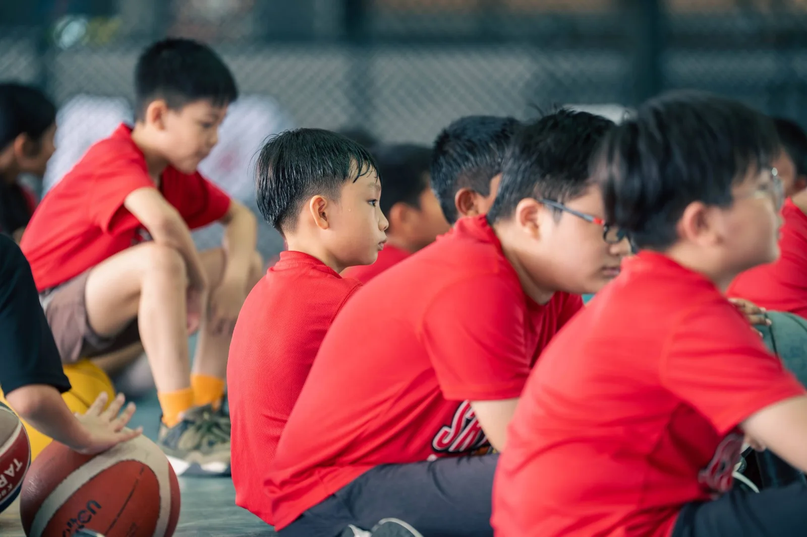 Kids ages 12–15 playing basketball
